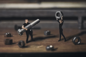 Man and a woman holding bolts and nuts