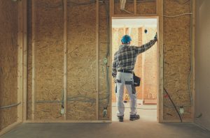 Person on a house being built