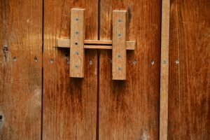 Wooden door with screwed handle