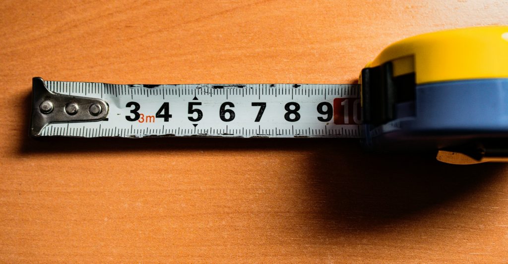 A tape measure on a wooden background