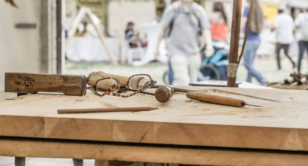 Eyeglasses and couple of hand tools on top of table