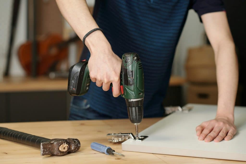 A person holding a hand tool