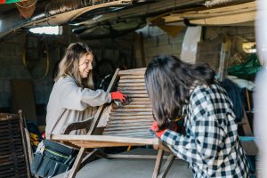 Two women working on a chair