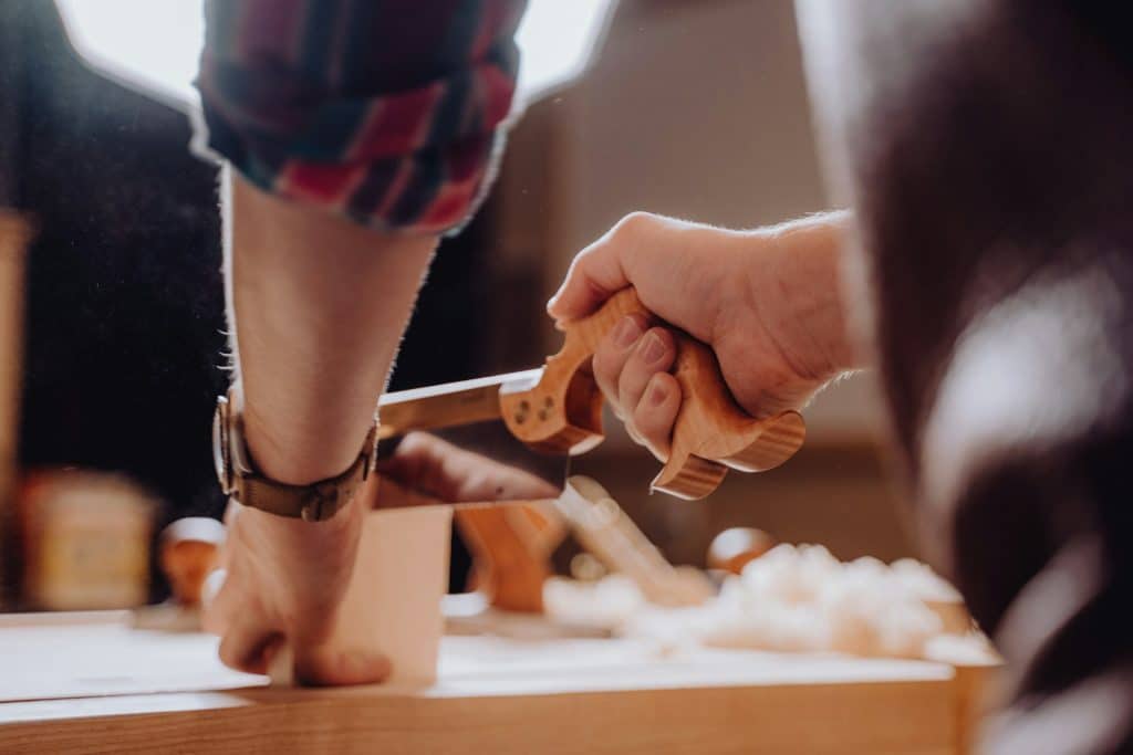 A person holding a hand tool